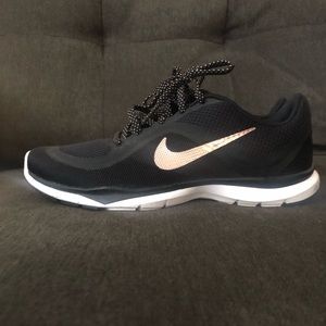 Rose gold and black Nike shoes